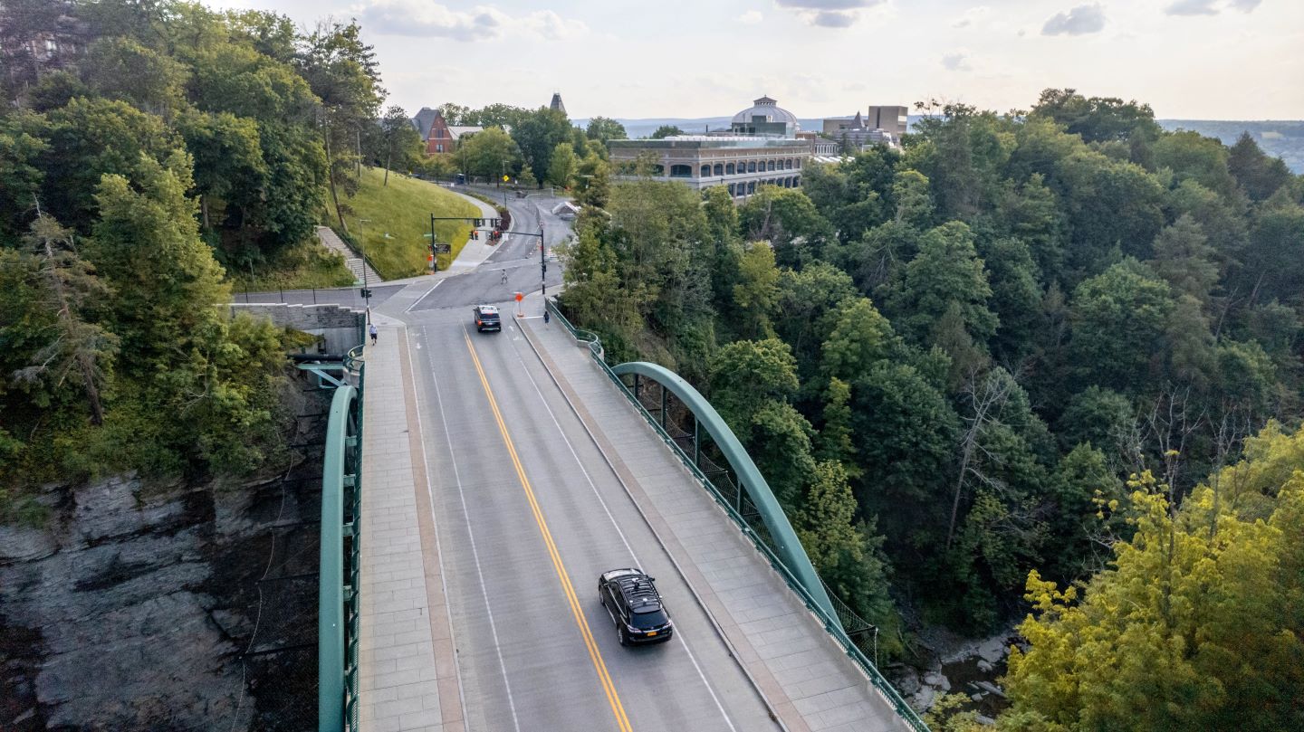aerial photo of two cars driving on a bridge